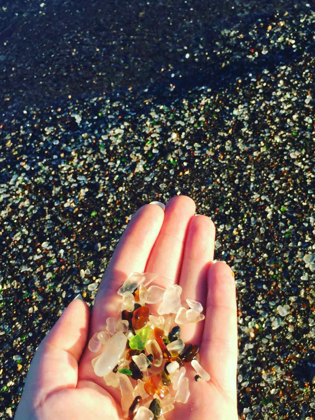 Sea glass on blogger Paula's hand at Glass Beach in Fort Bragg, California.