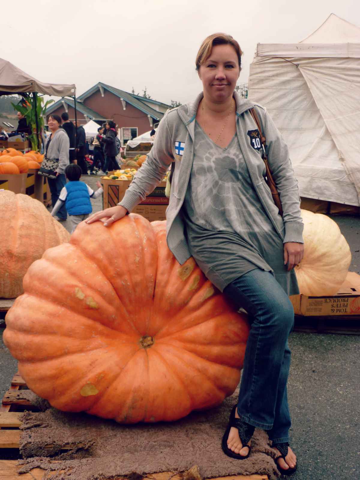 Blogger Paula with a giant pumpkin at Half Moon Bay Pumpkin Festival in California