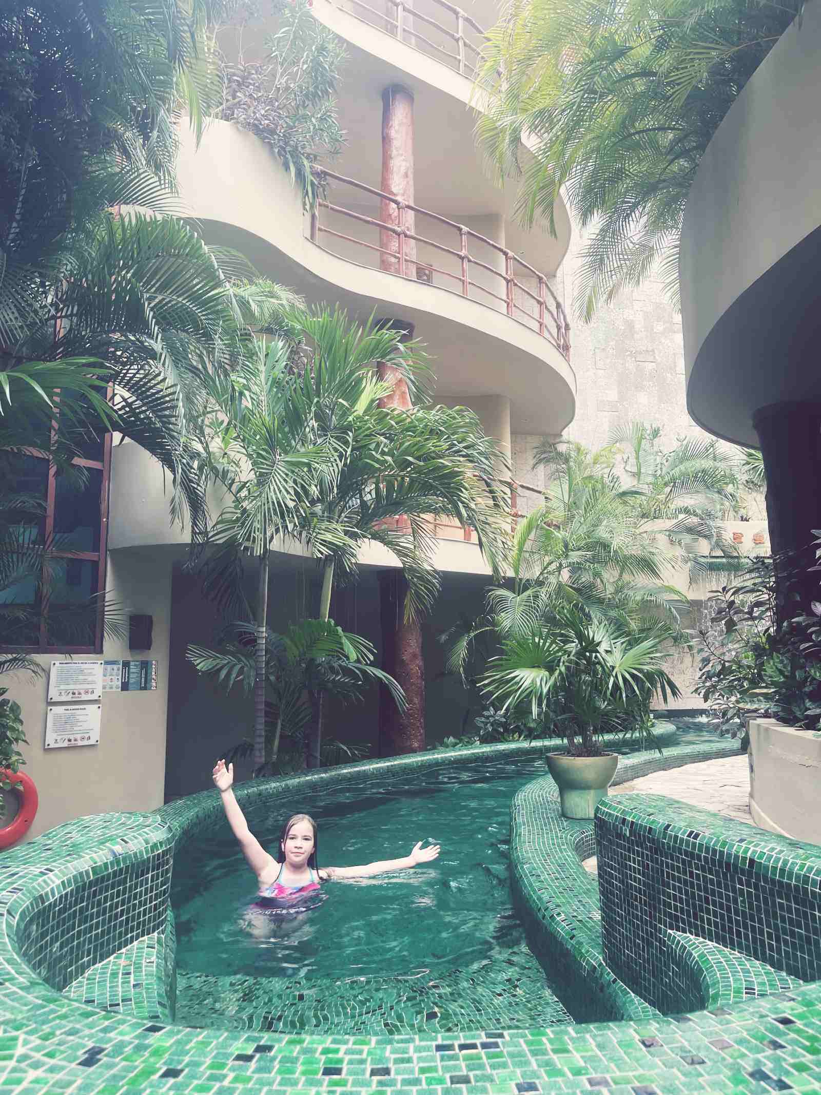 Our daughter at the pool at Maya Villa Condo Hotel.