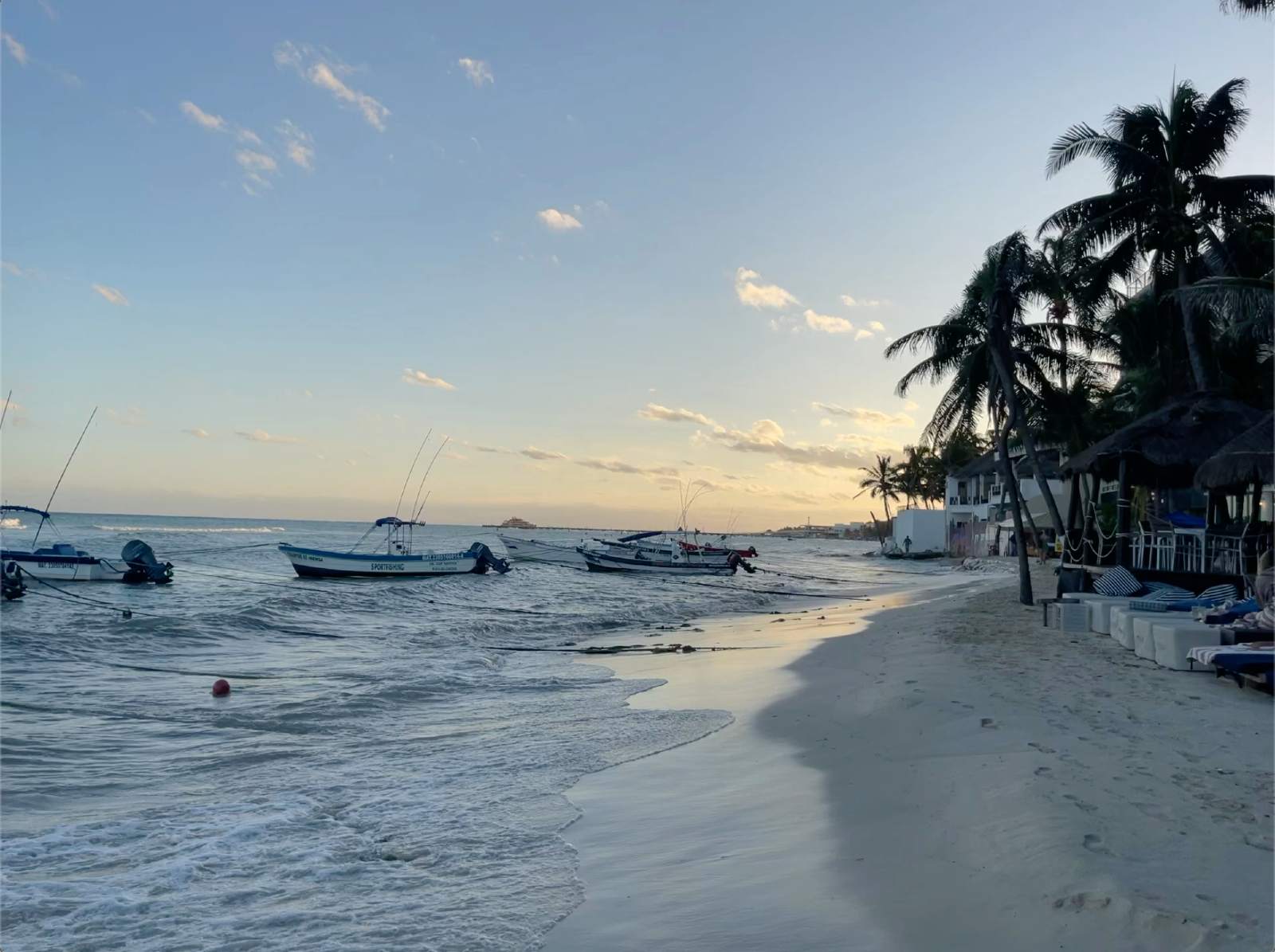 Fishing boats at Playa del Carmen beach in the evening.