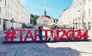 Our family by the Tartu 2024 sign in Estonia