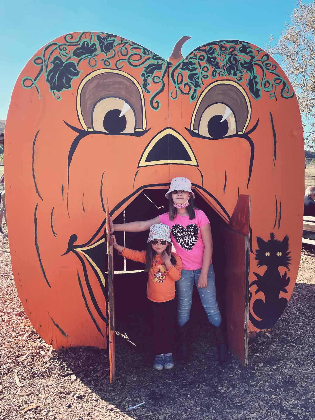 Our kids inside a pumpkin house in one of the best pumpkin patches to visit in SF Bay Area; Joan's pumpkin patch in Livermore.
