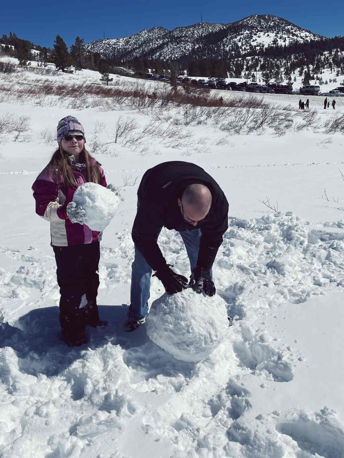 Our dad and our daughter building a snowman at North Lake Tahoe.