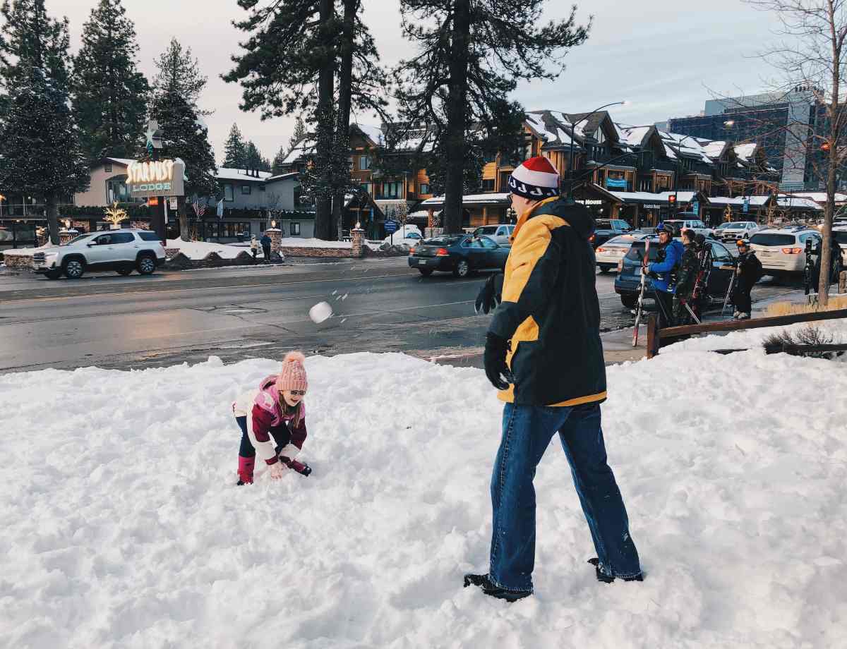 Our daughter and dad throwing snow balls at South Lake Tahoe, California