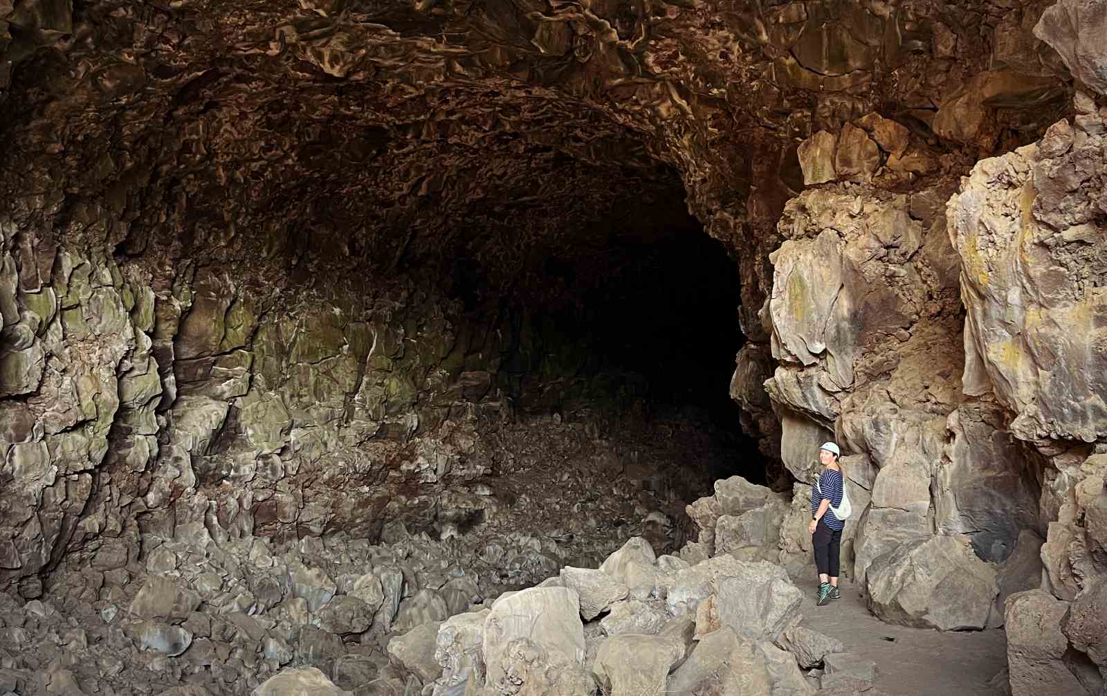 Blogger Paula in front of a cave entrance at Lava Beds National Monument in California