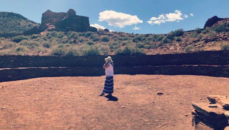 Blogger Paula looking at Wupatki pueblo at Wupatki National Monument in Arizona