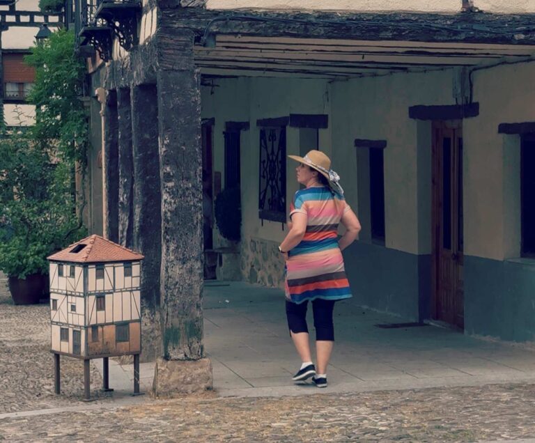 Blogger Paula walking and checking the local architecture in Covarrubias, Spain.